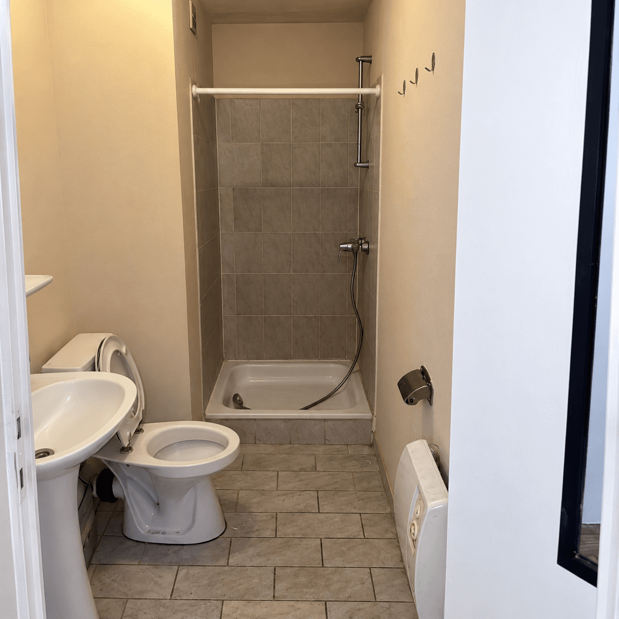 Salle d'eau datée avant rénovation, douche carrelée et sanitaires anciens, Anderlecht